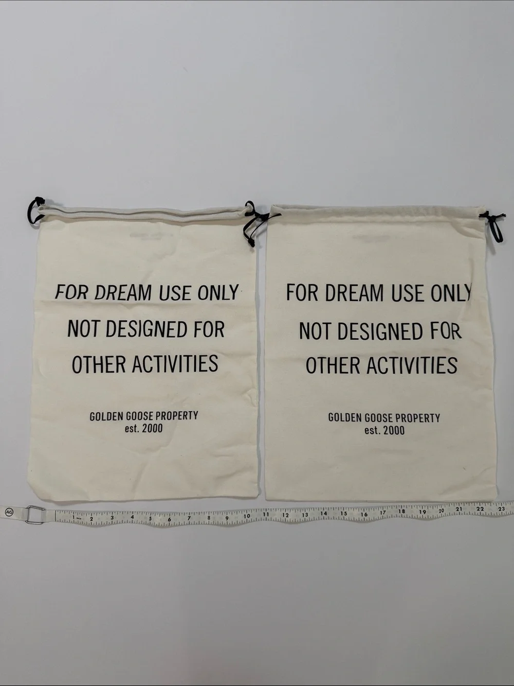 Golden Goose Cream Canvas Drawstring Bags with Black Text (Pair)